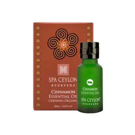 Cinnamon essential oil in green glass bottle with decorative box, ayurvedic wellness product