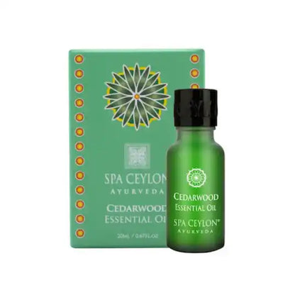 Cedarwood essential oil bottle with matching green gift box, ayurvedic aromatherapy product.
