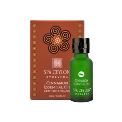 Cinnamon essential oil in green glass bottle with decorative box, ayurvedic wellness product