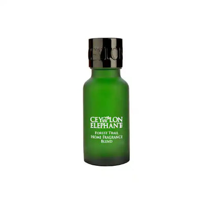 Green glass bottle labeled Ceylon Elephant Forest Trail Home Fragrance Blend