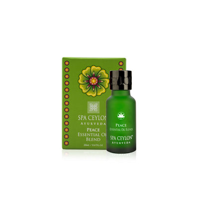 Green bottle of Peace essential oil blend with matching box, featuring floral design and gold accents