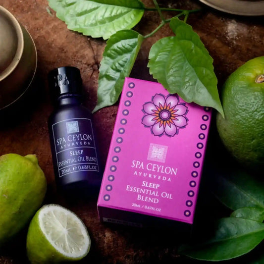 Sleep essential oil blend bottle and box with citrus fruits and green leaves on wooden surface