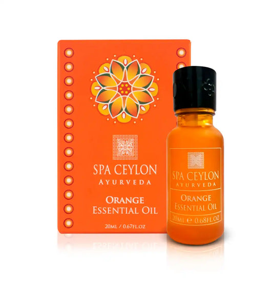 Orange essential oil bottle and box with mandala design, labeled Spa Ceylon Ayurveda.