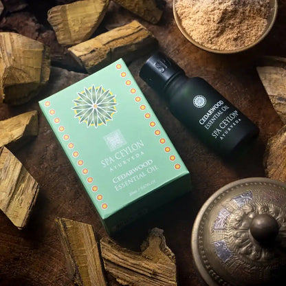 Cedarwood essential oil bottle and box with wood pieces on a rustic surface, aromatherapy setting